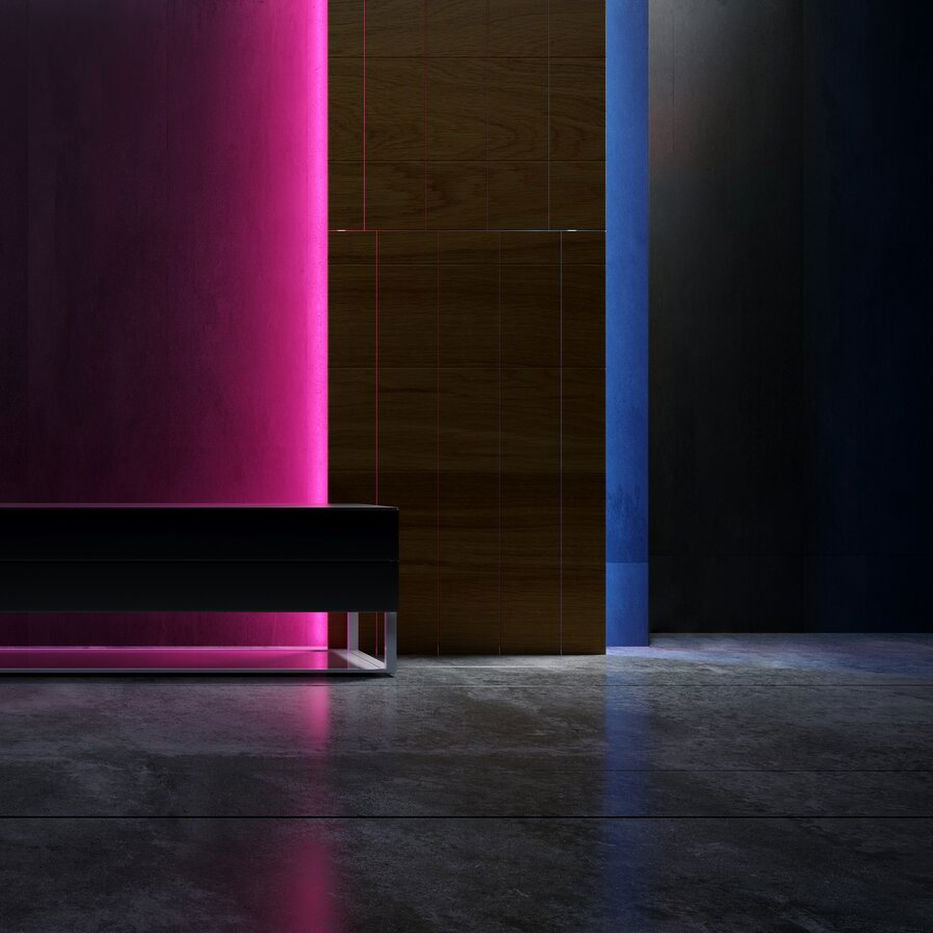 Modern black sofa against a dark wall with rgb neon light