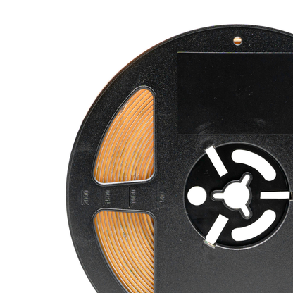 Close-up of a reel to reel tape with visible label on a white background