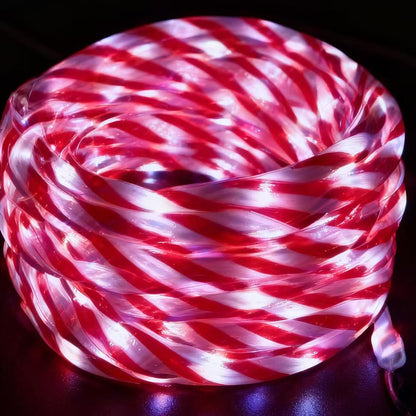 Coiled red and white LED rope light on a dark background