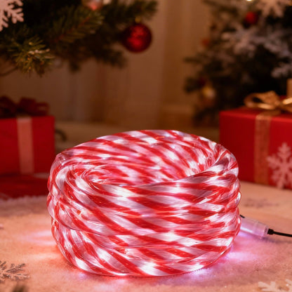 Candy cane-patterned LED rope light on a festive background with Christmas decorations.